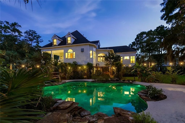 view of pool at dusk