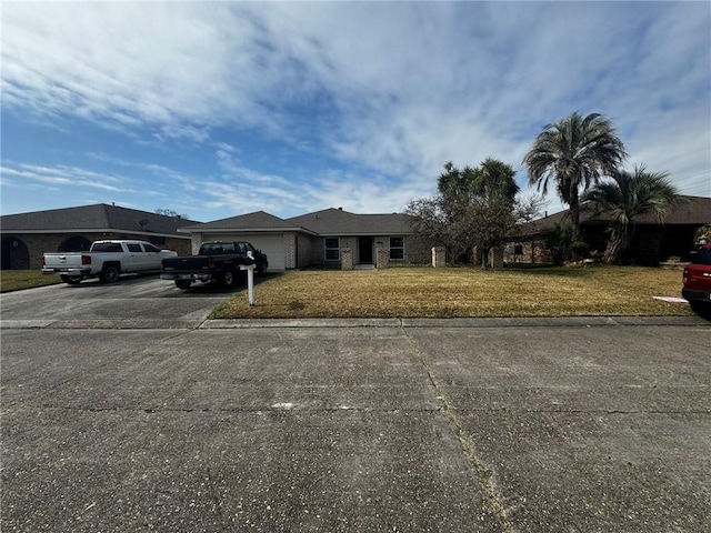 single story home featuring a garage and a front lawn