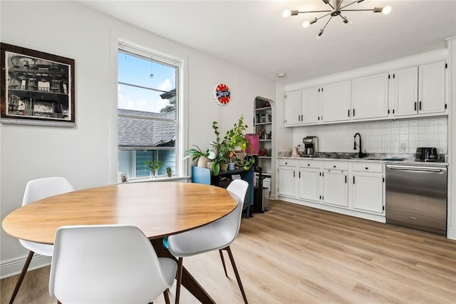 dining room with sink and light hardwood / wood-style flooring