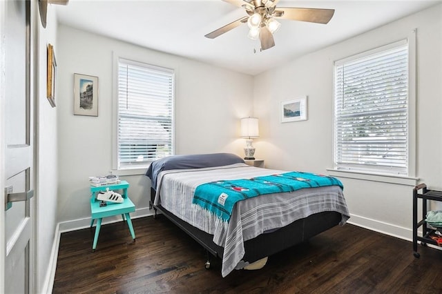 bedroom with dark hardwood / wood-style floors and ceiling fan