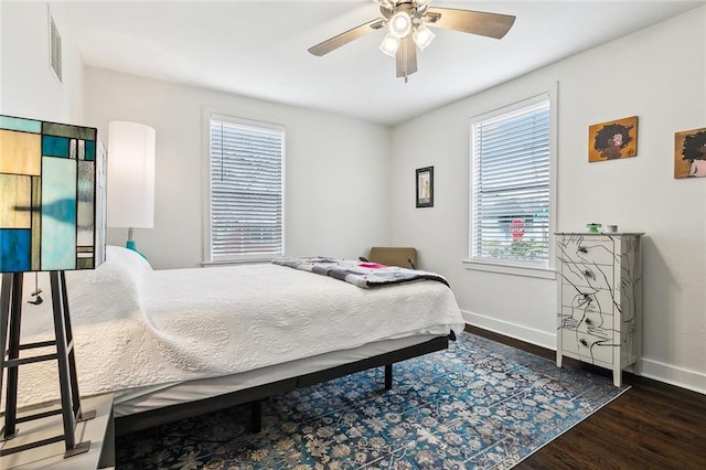 bedroom with dark wood-type flooring and ceiling fan