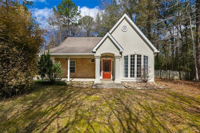 view of front of house with a patio area and a front lawn