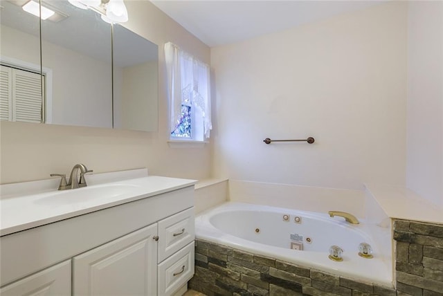 bathroom with vanity and tiled tub