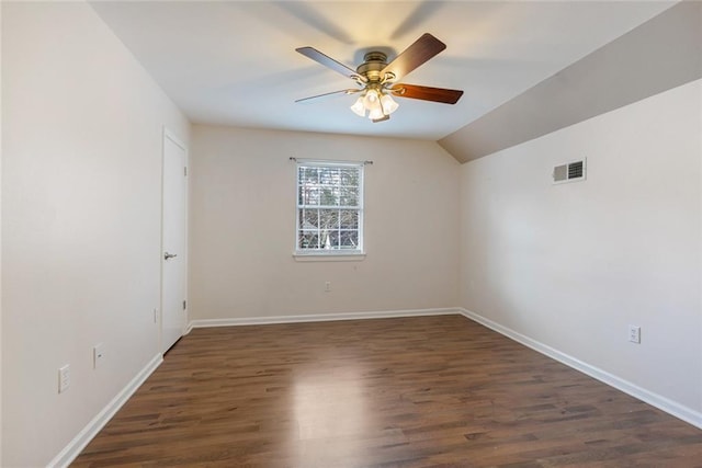 empty room featuring ceiling fan, lofted ceiling, and dark hardwood / wood-style floors