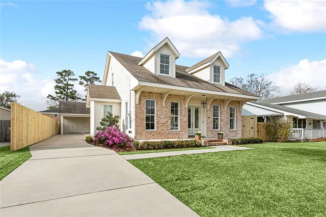 cape cod-style house featuring a porch, a garage, and a front lawn