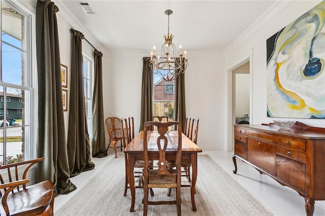 dining room with crown molding and a chandelier