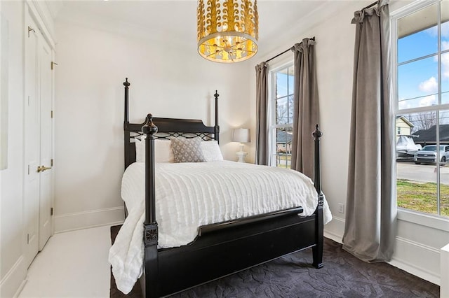 bedroom with ornamental molding and a chandelier