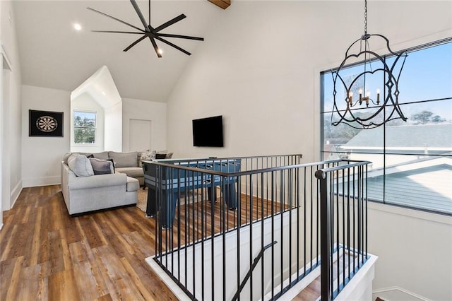 living room with hardwood / wood-style flooring, high vaulted ceiling, and a notable chandelier