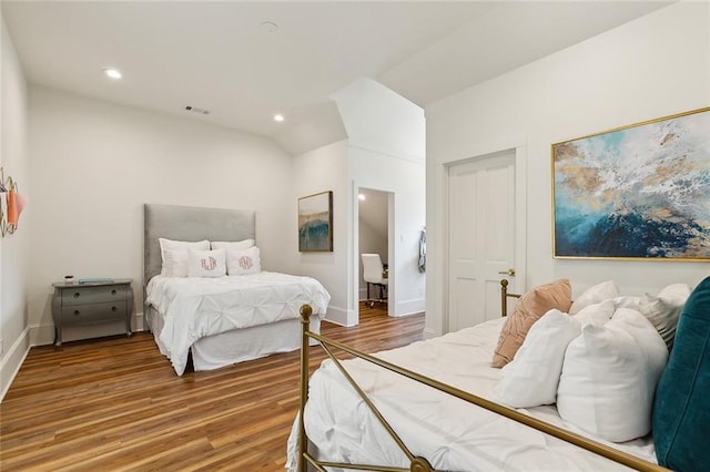 bedroom featuring vaulted ceiling and hardwood / wood-style floors