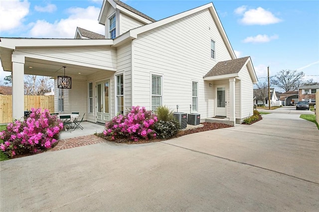 rear view of property featuring central AC