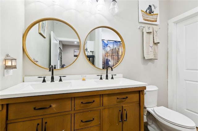 bathroom featuring vanity and toilet