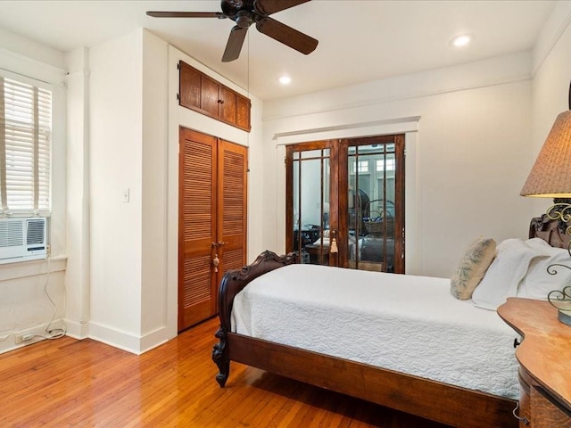 bedroom featuring french doors, recessed lighting, a closet, light wood-style flooring, and baseboards