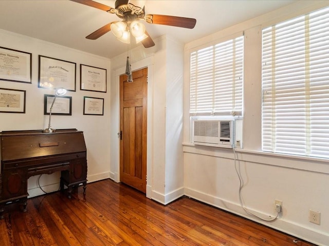 interior space featuring cooling unit, ceiling fan, baseboards, and wood finished floors