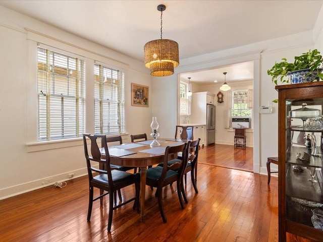 dining space with dark wood-style floors and baseboards