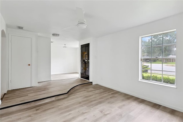 1751 Holiday Dr, New Orleans, LA 70114 - empty room with light wood finished floors, baseboards, visible vents, and a ceiling fan