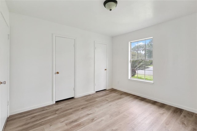 1751 Holiday Dr, New Orleans, LA 70114 - unfurnished bedroom with light wood finished floors and baseboards