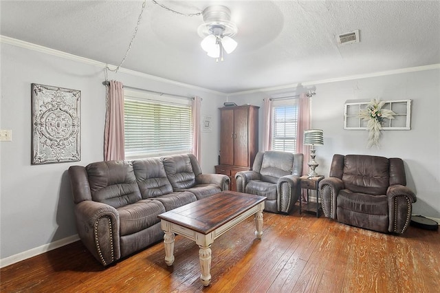 living room featuring hardwood / wood-style flooring, ceiling fan, crown molding, and a textured ceiling