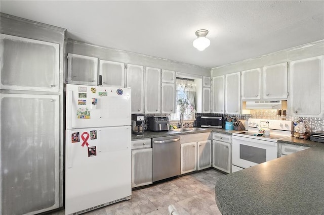 kitchen featuring tasteful backsplash, white appliances, sink, and white cabinets