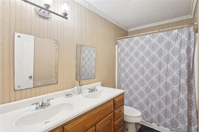 bathroom featuring ornamental molding, vanity, toilet, and a textured ceiling