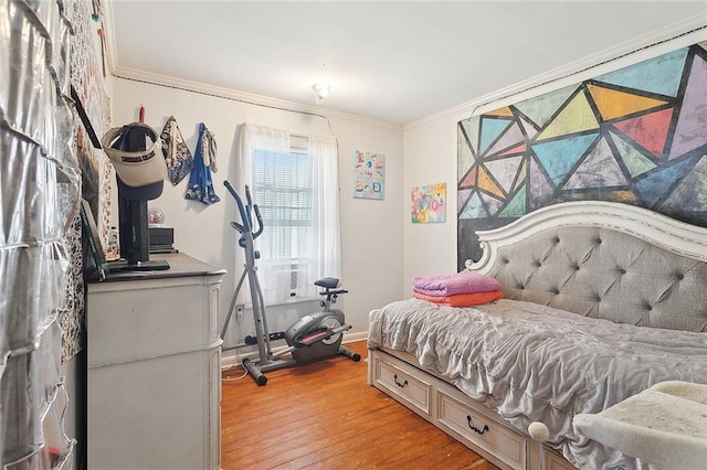 bedroom featuring ornamental molding and light hardwood / wood-style floors