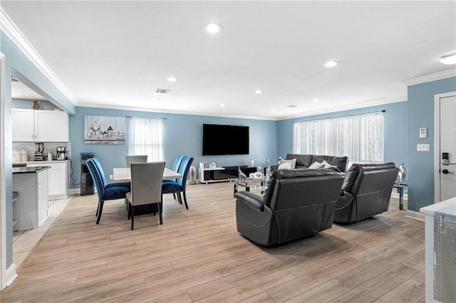 living room featuring crown molding and light hardwood / wood-style floors