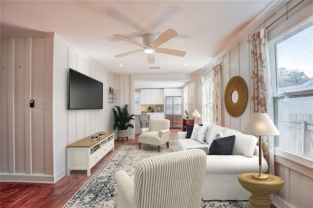 living room with dark hardwood / wood-style floors and ceiling fan