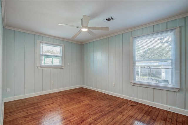 spare room featuring crown molding, ceiling fan, and light hardwood / wood-style flooring