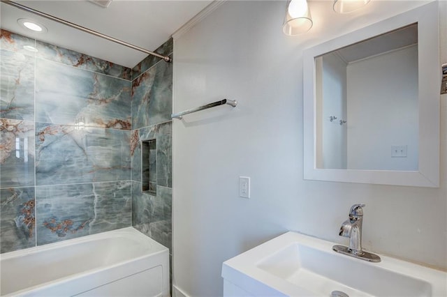 bathroom featuring tiled shower / bath and sink