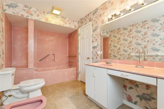 full bathroom featuring a bidet, vanity, washtub / shower combination, and toilet