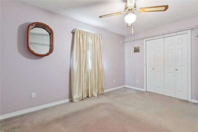 unfurnished bedroom featuring light carpet, a closet, and ceiling fan