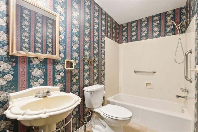 full bathroom with sink, washtub / shower combination, toilet, tile patterned floors, and a textured ceiling