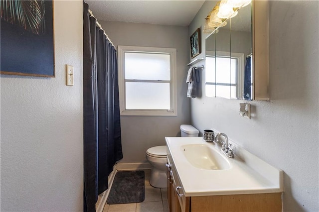 bathroom with vanity, tile patterned flooring, and toilet