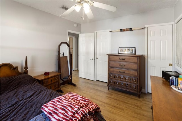 bedroom with ceiling fan and wood-type flooring