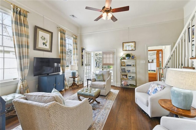 living room with ceiling fan and dark hardwood / wood-style flooring