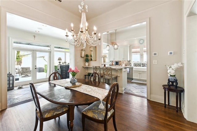 dining area with dark wood-type flooring, a wealth of natural light, and french doors