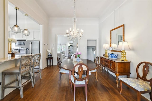 dining room with an inviting chandelier and dark hardwood / wood-style flooring