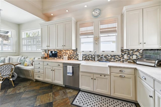 kitchen featuring stainless steel dishwasher, sink, decorative backsplash, and white cabinets