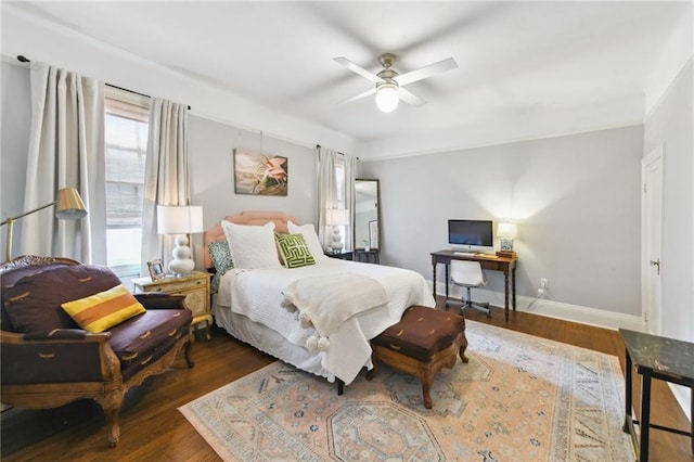 bedroom with ceiling fan and dark hardwood / wood-style flooring