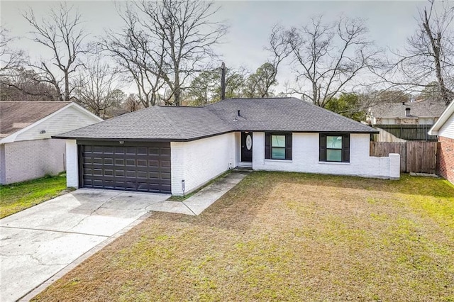 ranch-style house featuring a garage and a front lawn