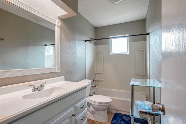 full bathroom featuring shower / bathtub combination, wood-type flooring, vanity, toilet, and a textured ceiling