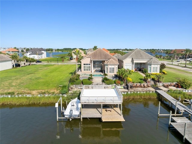 view of dock with boat lift, a lawn, and a water view