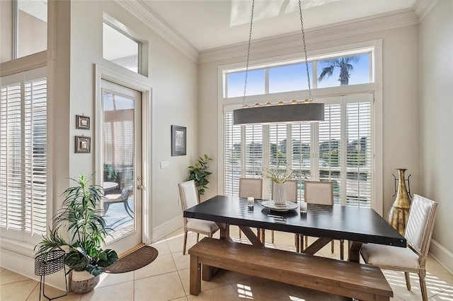 dining area with light tile patterned floors, baseboards, and ornamental molding