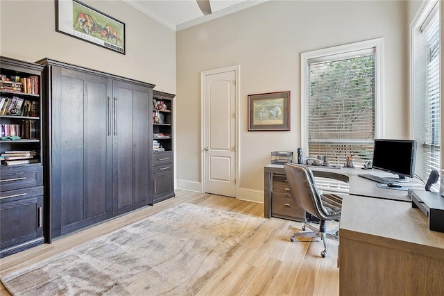 office area featuring light wood-style flooring, crown molding, and baseboards