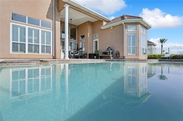 view of pool featuring a swimming pool and fence