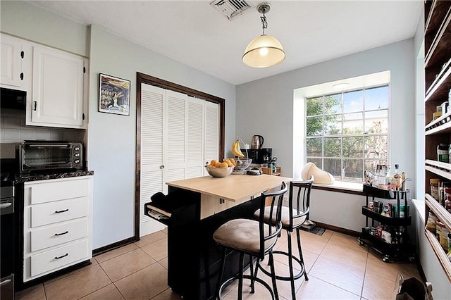 dining space featuring light tile patterned flooring