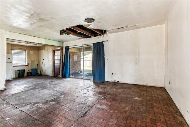 unfurnished room featuring plenty of natural light