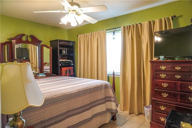 tiled bedroom featuring ceiling fan