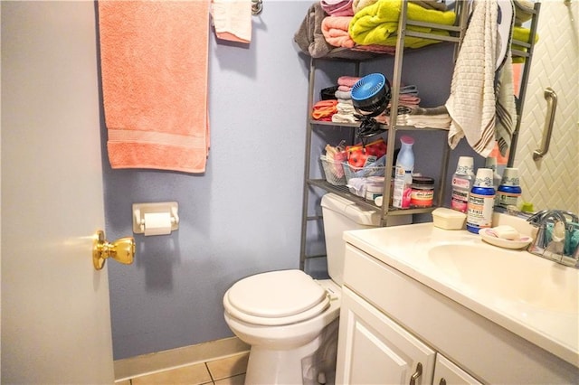 bathroom featuring vanity, tile patterned floors, and toilet