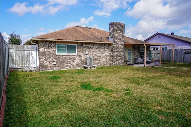 rear view of house with central AC, a lawn, and a patio