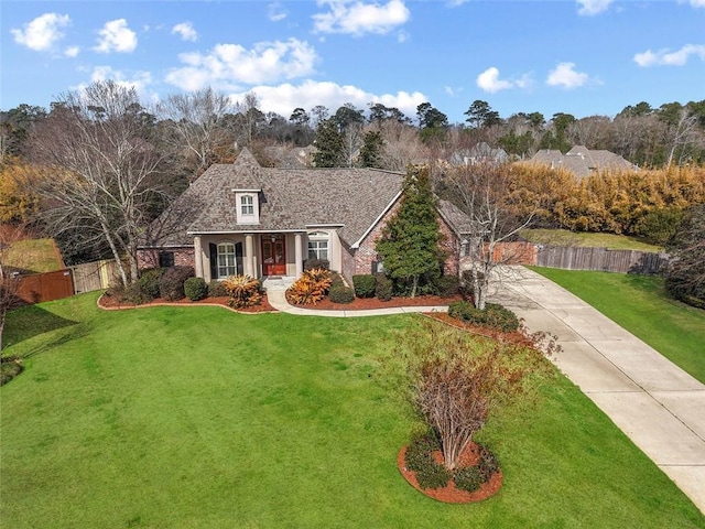 cape cod-style house with a front yard